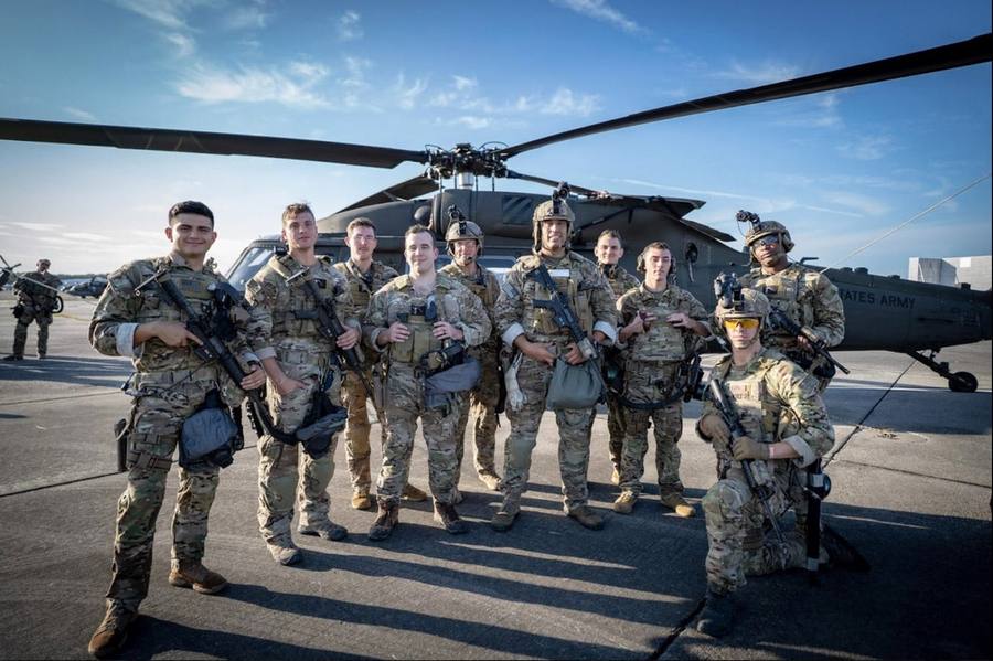 Andrew Eberly with his unit in front of a helicopter